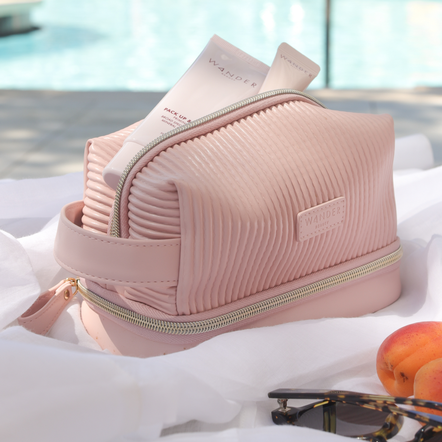 Pink Wander Beauty Makeup Bag with Makeup and Skincare Products inside